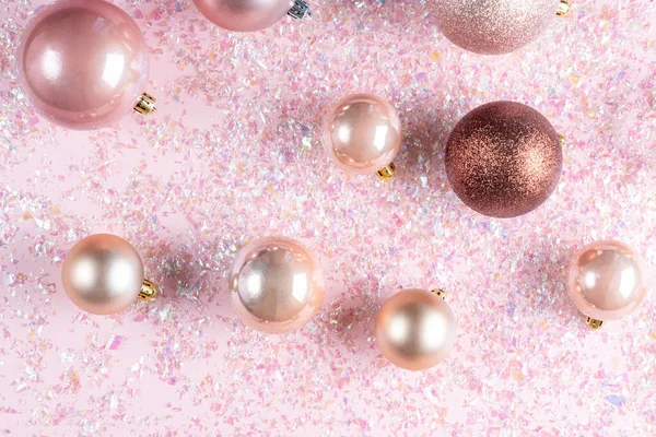 Christmas composition of decoration balls on pink background with glitter. Flat lay, top view — Stock Photo, Image