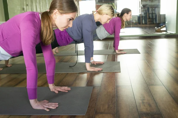 Yoga klass, grupp av folk som kopplar av och gör Yoga poserar. Hälsa och hälsosam livsstil. — Stockfoto