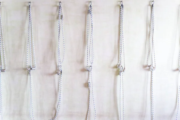 Yoga ropes hanging on studio wall. Iyengar yoga props — Stock Photo, Image