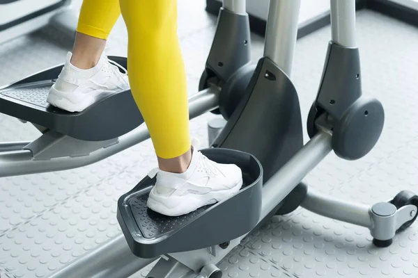 Woman Working Out On Elliptical Machine in gym — 스톡 사진