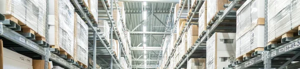 Rows of shelves with boxes in modern warehouse — Stock Photo, Image