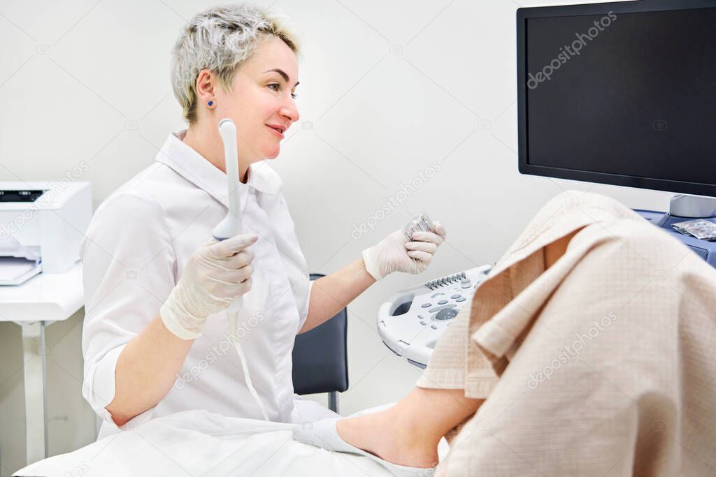 Gynecologist doing ultrasound scan in modern clinic