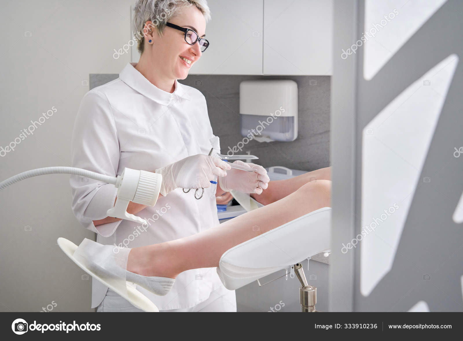 Gynecologist with vaginal speculum in clinic before patient examination Stock Photo by