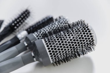Set of professional hairbrushes on white background in hair salon