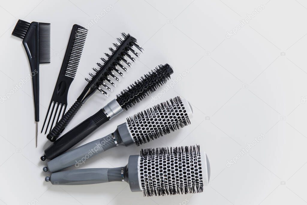 Set of professional hairbrushes on white background in hair salon