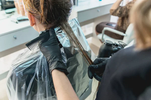 Woman having hair foiled while coloring in hair salon — Stock Photo, Image