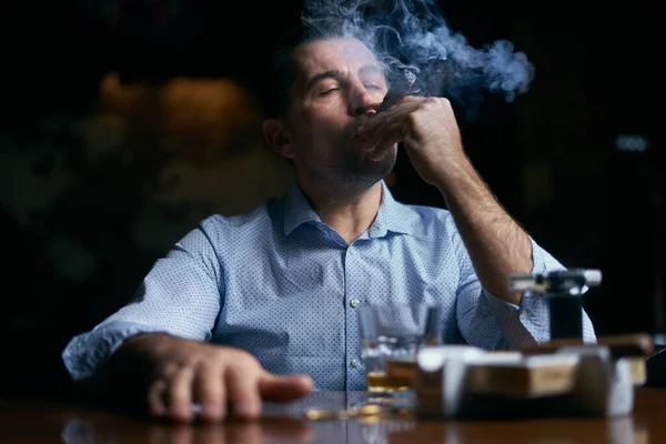 Porträtt av hansome man rökning cigarr i en lounge bar — Stockfoto