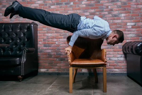 Businessman doing yoga posing duringwork break ロイヤリティフリーのストック写真