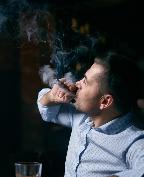 Portrait of hansome man smoking cigar in a lounge bar — Stock Photo, Image