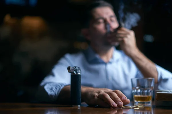 Portrait of hansome man smoking cigar in a lounge bar — Stock Photo, Image