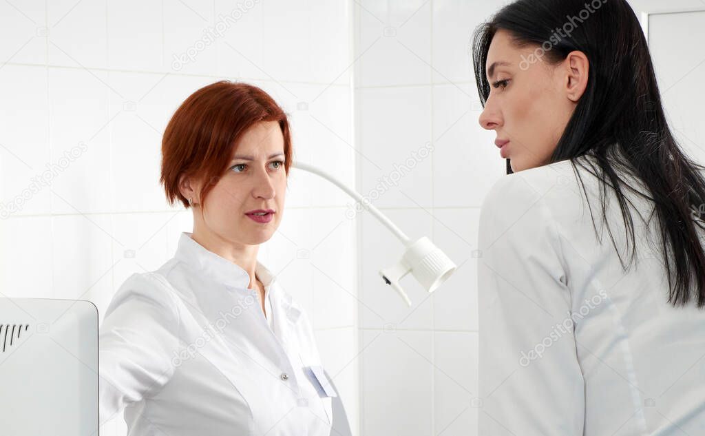 Gynecologist ready to do transvaginal ultrasound with wand and exam a woman