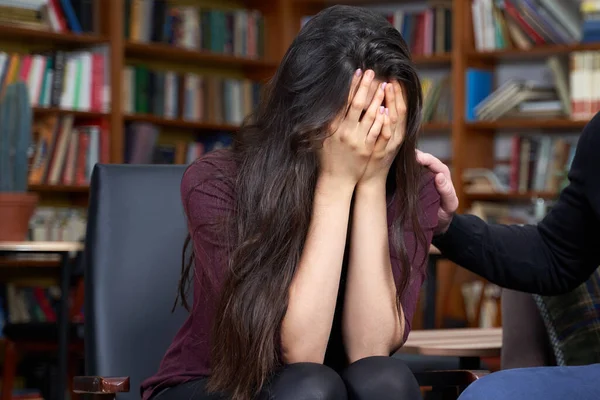 Mujer joven en el psicólogo, sintiéndose desesperada y deprimida, llorando sosteniendo su cabeza en las manos, molesta adolescente — Foto de Stock