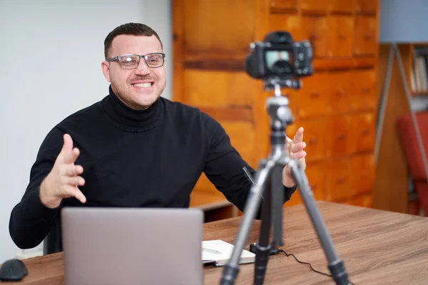 Hombre filmando video blog en cámara con trípode para seguidores en línea. En las redes sociales, Influencer, nuevas tecnologías y concepto de internet —  Fotos de Stock