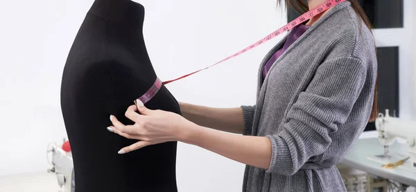 Cropped view of seamstress measuring black dummy in workshop, tailor studio work — Stock Photo, Image