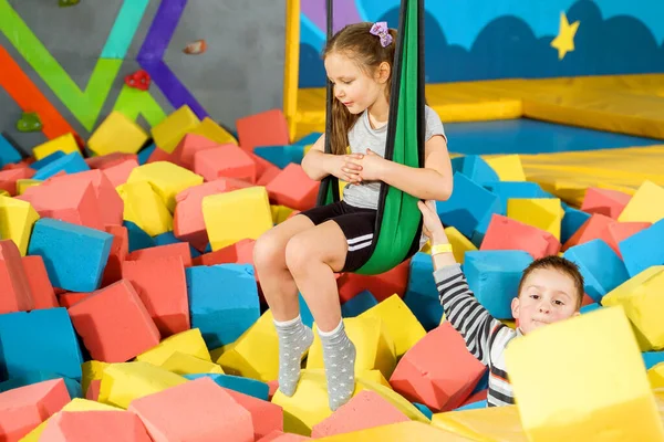 Children playing with soft cubes in the dry pool in play center. playground with foam blocks in trampoline club — Stock Photo, Image