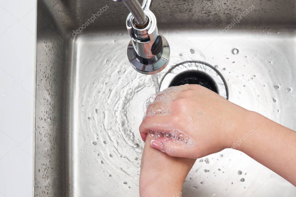 Woman washing hands with antibacterial soap for corona virus prevention, hygiene to stop spreading coronavirus