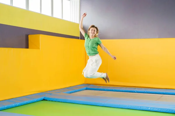 Młoda dziewczyna skacze na trampolinie w centrum sportu — Zdjęcie stockowe