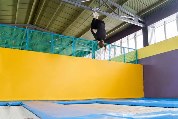 Teenagermädchen springt in Fitnessstudio auf Trampolin — Stockfoto