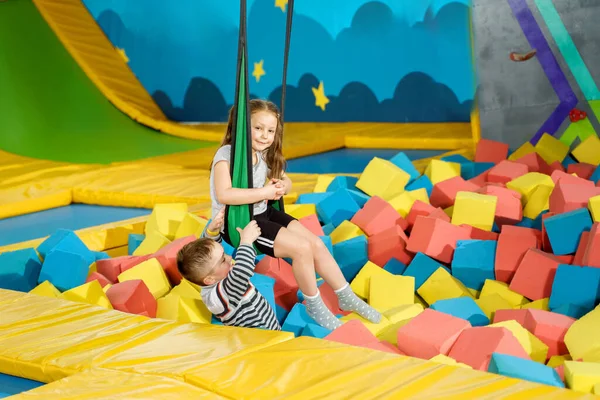 Children playing with soft cubes in the dry pool in play center. playground with foam blocks in trampoline club — Stock Photo, Image