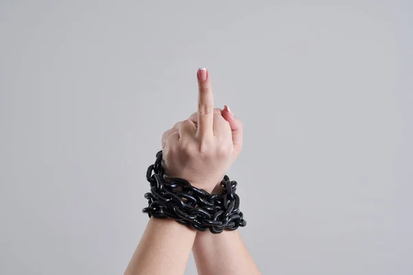 Female chained fist showing a fuck you sign — Stok fotoğraf