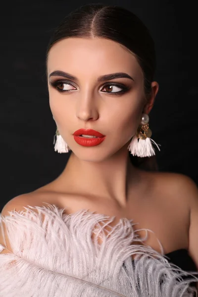 Sensual woman with dark hair and bright makeup with accessories — Stock Photo, Image