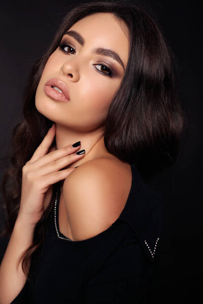 gorgeous woman with dark hair in elegant clothes