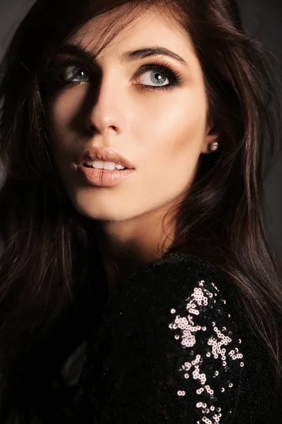 Gorgeous woman with long dark hair posing in studio — Stock Photo, Image