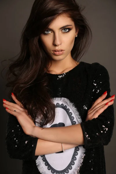 Gorgeous woman with long dark hair posing in studio — Stock Photo, Image