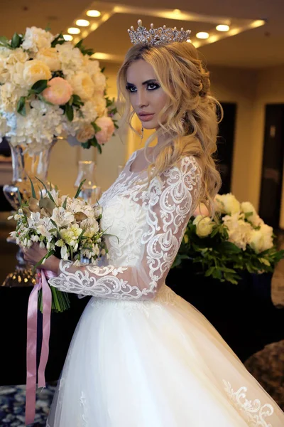 Gorgeous bride with blond hair in luxurious wedding dress — Stock Photo, Image