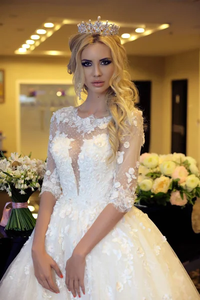 Gorgeous bride with blond hair in luxurious wedding dress — Stock Photo, Image