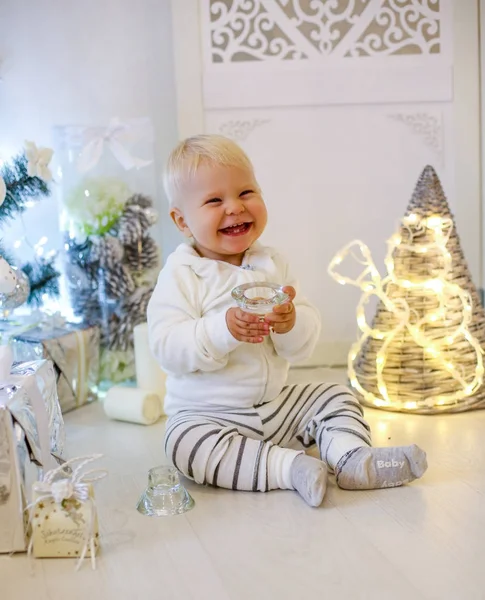 Cute 1 year old baby boy in cozy clothes, posing in New Year dec — Stock Photo, Image