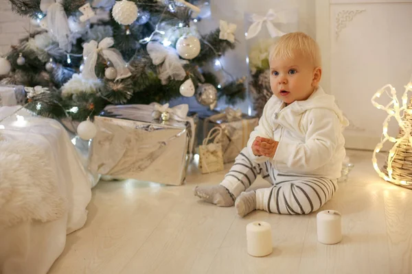Милий однорічний хлопчик в затишному одязі, позує в новорічну ніч — стокове фото