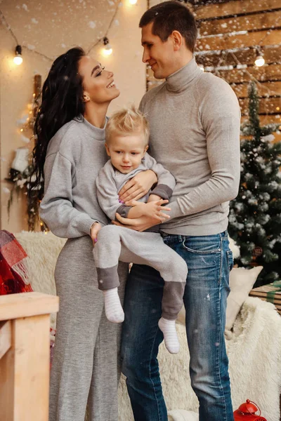 Beautiful happy family celebrating Christmas at cozy decorated h — Stock Photo, Image