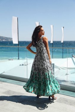 beautiful sensual woman with dark hair in elegant dress posing o