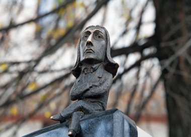 Small iron cast netsuke statuette on top of the monument to Franz Liszt  in Chernivtsi town, Ukraine clipart