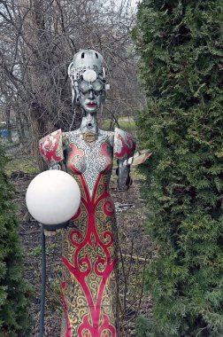 Lamppost in view of female steampunk decorative statue keeping lamp in the yard of the beer restaurant Kovcheg (Ark)  in Ternopil, Ukraine