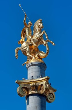 Golden Monument of St. George killing the dragon on Freedom Square of Georgia in Tbilisi