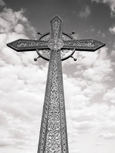 Orthodox cross against the background of the blue cloudy sky