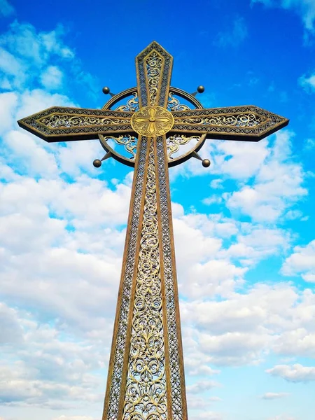 Orthodox cross against the background of the blue cloudy sky