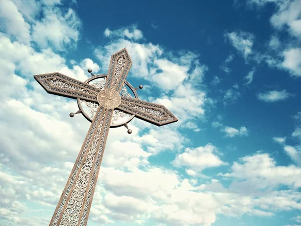 Orthodox cross against the background of the blue cloudy sky