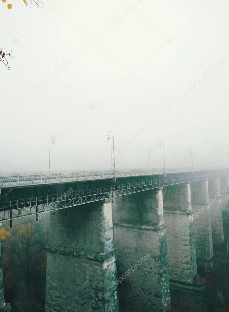 The bridge to the Old Town over canyon on a dull foggy day, Kamenets-Podolsky, Ukraine