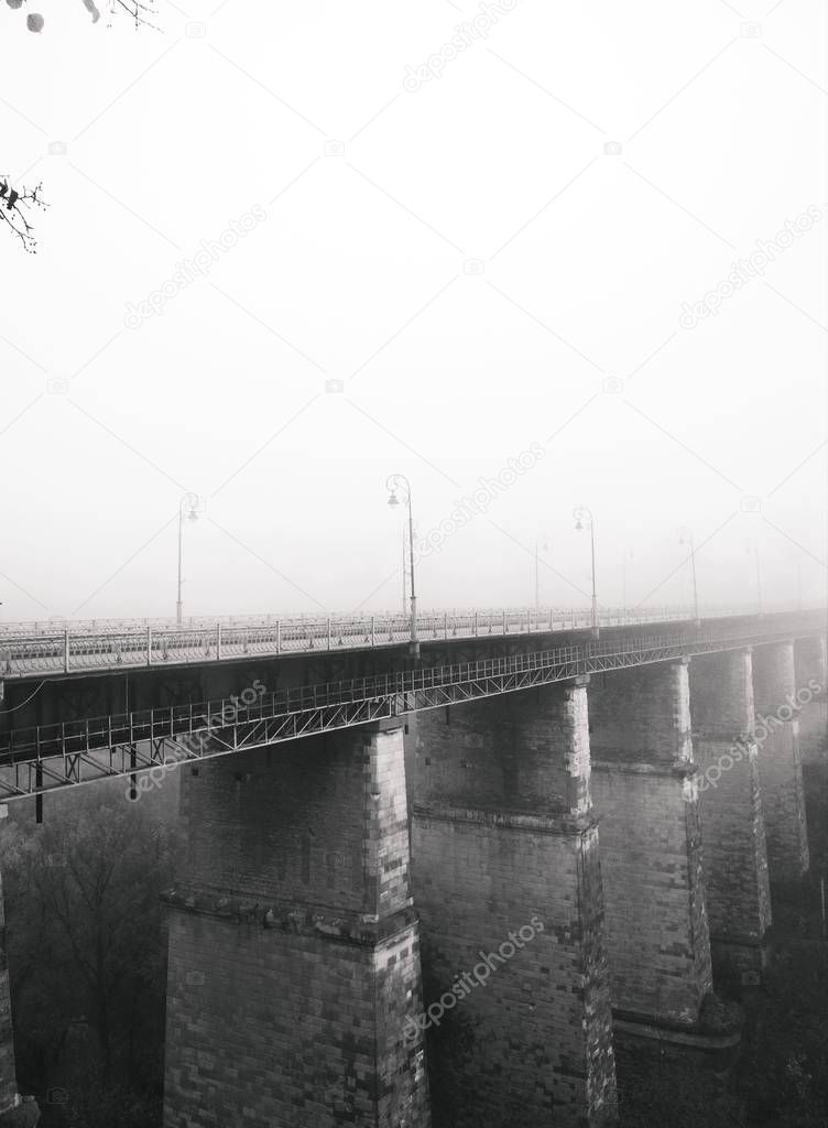 The bridge to the Old Town over canyon on a dull foggy day, Kamenets-Podolsky, Ukraine