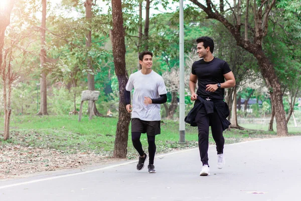 Two men jogging in the morning at the park