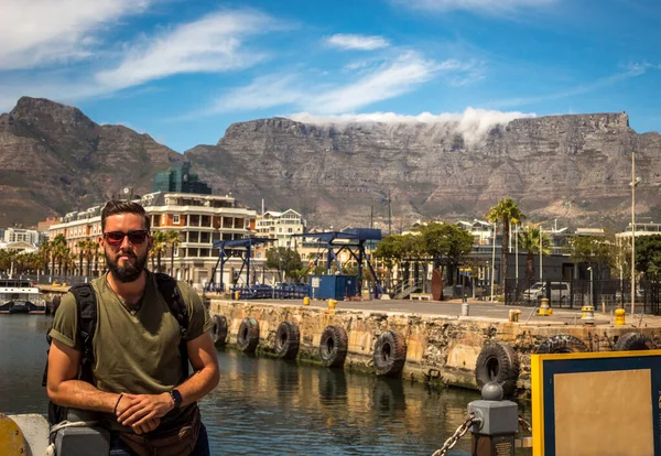 Young man posing in Cape Town. Bearded man with the table mountains as background