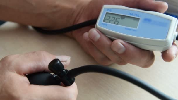 Man measuring blood pressure at home — Stock Video