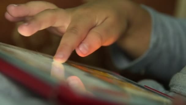 Маленький хлопчик розважається з грою на планшетному ПК — стокове відео