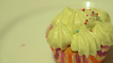 Cupcake with cream and sugar beads on the top