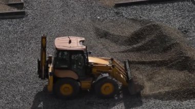 Tractor grabbing gravel