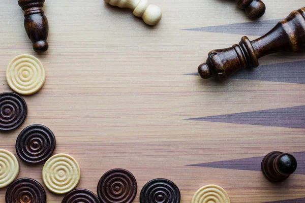 chess and checkers made of wood on a game board