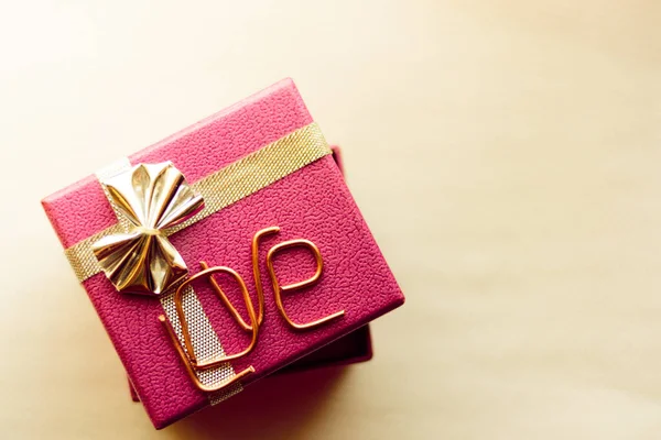 holiday gift box with the inscription love made of copper letters